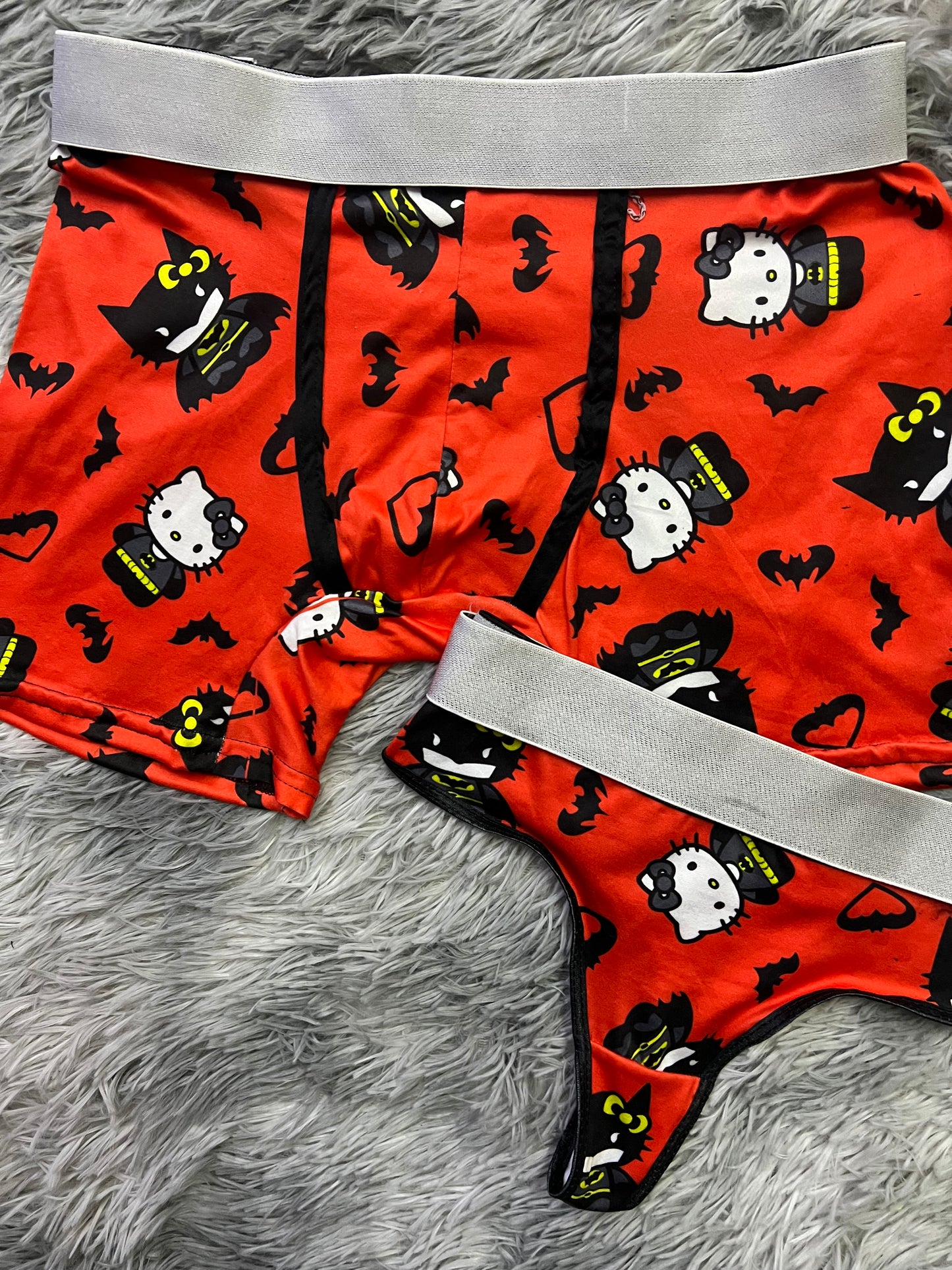 Hello Kitty dressed as Batman orange background matching underwear