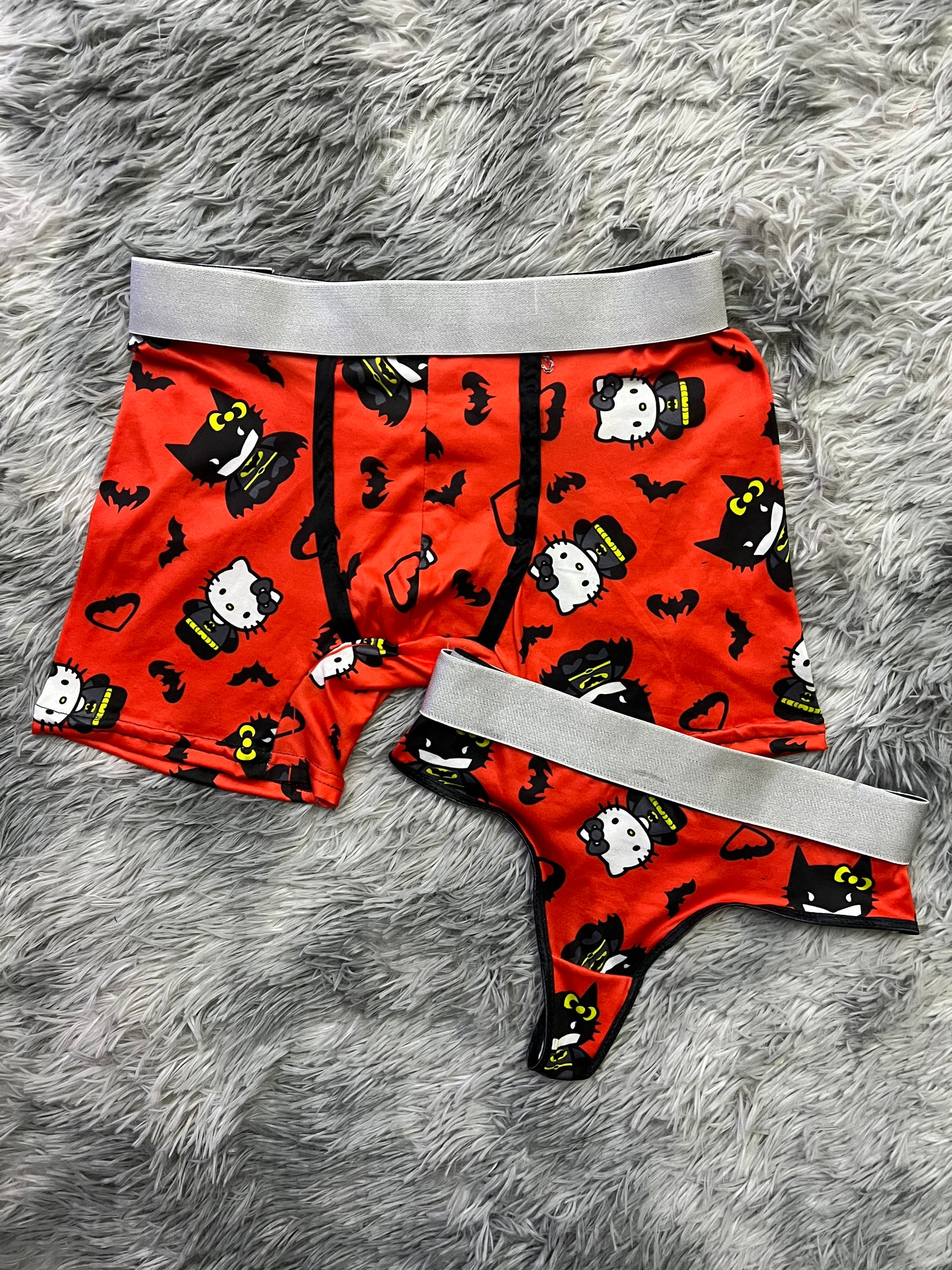 Hello Kitty dressed as Batman orange background matching underwear